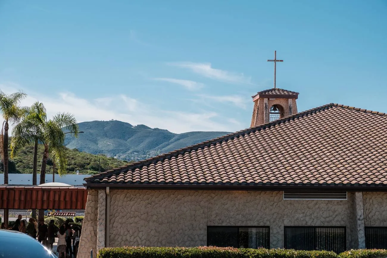 The Abbey's terracotta roof and bell tower against the hills.